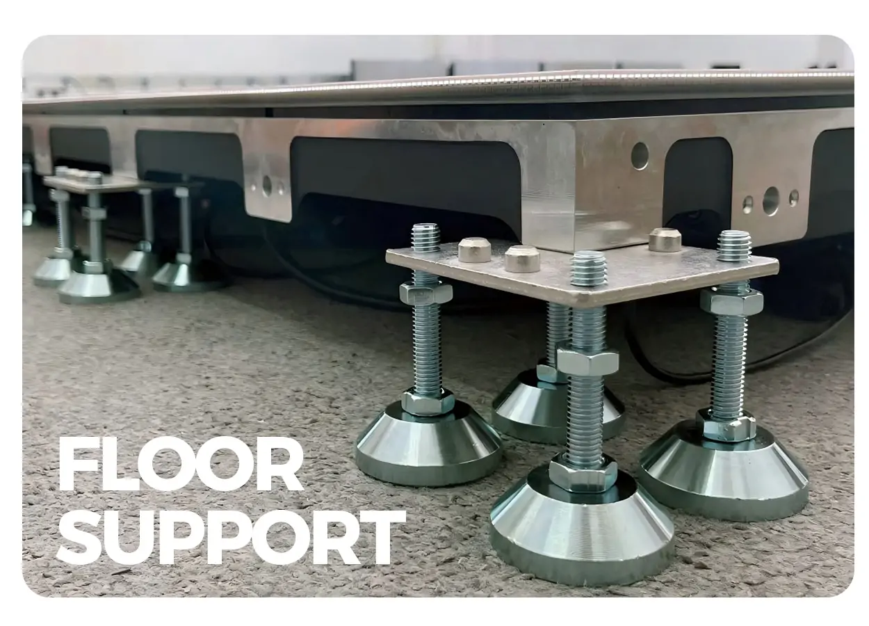 Close-up of adjustable floor supports under a metal platform, showing threaded rods and conical feet; the words FLOOR SUPPORT appear in the lower left corner.