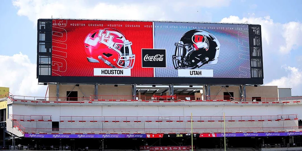 Football stadium LED jumbotron displaying team matchup graphics