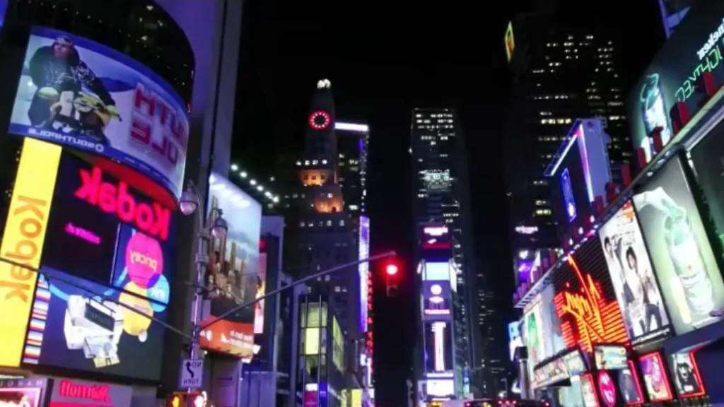 Large outdoor LED screens displaying colorful advertising in a city at night