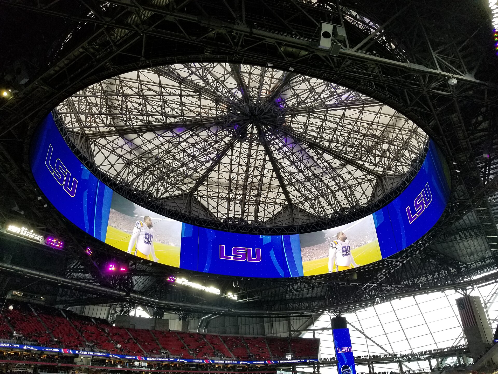 Centre-hung halo LED video board suspended above an indoor arena crowd