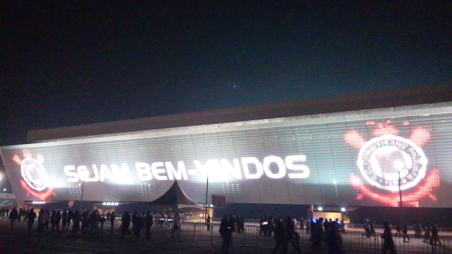 Large stadium LED video screen covering the exterior facade of a venue to illustrate how screen area drives cost