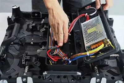 Power supply and wiring being fitted inside an LED display cabinet