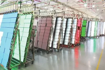 LED modules displaying test colours on factory aging racks